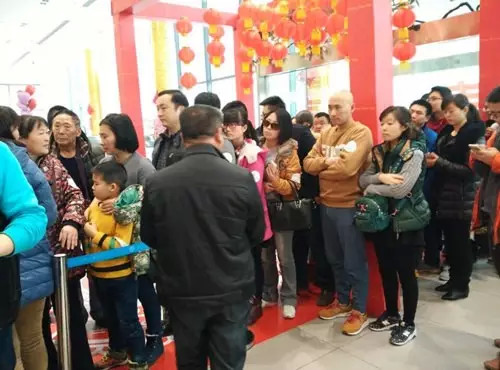 排隊(duì)領(lǐng)年貨，一家老小齊上陣。