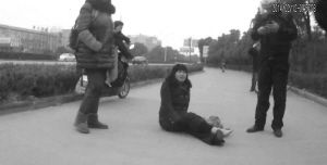 鄭大姐坐在地上，警方趕到進(jìn)行施救。（視頻截圖由警方提供）