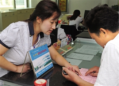 一位男士在金水區(qū)房管局辦事窗口詢問公租房申請手續(xù)如何辦理。