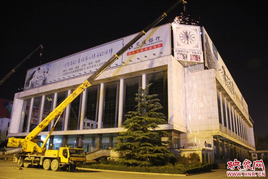 21點(diǎn)50分，切割機(jī)開始對(duì)中間最小的一塊牌進(jìn)行切割。頂著“呼呼”的寒風(fēng)，巨大廣告牌上火花四濺。