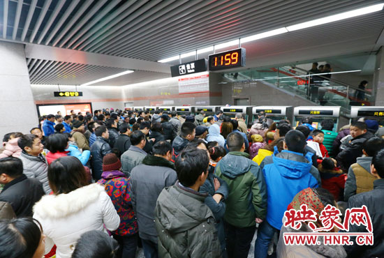 地鐵開通首日，上午十一點五十九分，紫荊山地鐵站售票機(jī)前擠滿了買票的市民。