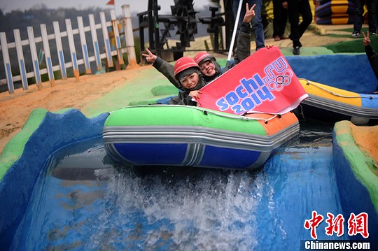 　圖為外國友人舉著標(biāo)語體驗水上漂。陳超　攝